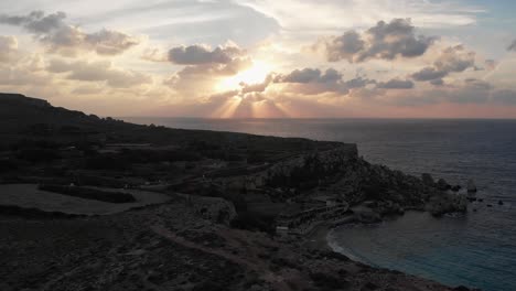 Aerial-drone-video-from-north-of-Malta,-Cirkewwa,-flying-over-Paradise-bay-at-sunset