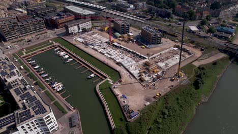Aerial-rotating-pan-showing-construction-site-of-luxury-apartment-Kade-Zuid-complex-being-build-in-former-industrial-area