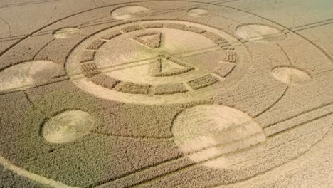 Swarraton-golden-barley-field-strange-ufo-crop-circle-design-aerial-view-orbit-low-right-flying-above-Hampshire-farmland