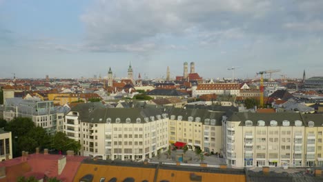 Low-Aerial-Flight-Over-Beautiful-Munich-Apartment-Buildings,-Marienplatz-in-Background