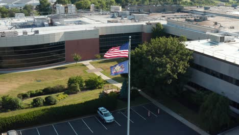 American-USA,-Pennsylvania-flags-at-corporate-office-building,-manufacturing-plant,-facility