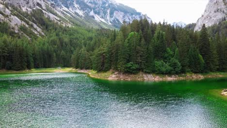 AREAL---Green-Lake-Styria-Austria---forward-movement-trough-trees,-wide-shot