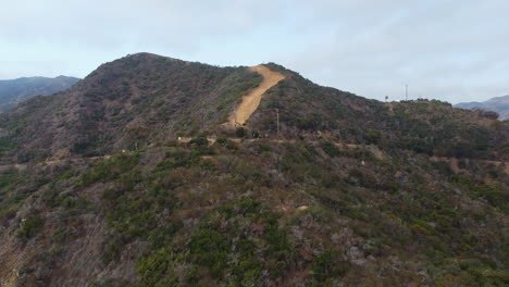 Drone-Zoom-Out-of-Catalina-Island-Mountain-Peak-and-Hillside-Slope-on-Cloudy-Day