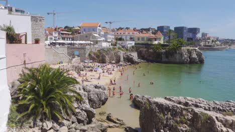 A-Warm-Summer-Scene-of-Rainha-Beach-in-Cascais,-Portugal-full-of-People