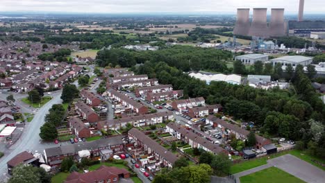 British-industrial-residential-neighbourhood-aerial-view-across-power-station-suburban-houses-and-streets-wide-left-orbit