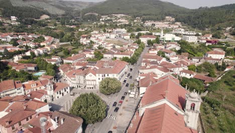 Beautiful-rooftops-of-Arouca-town-surrounded-by-mountain-range,-aerial-drone-view