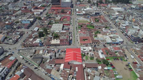 Drone-aerial-footage-of-central-american-urban-city-commercial-streets-with-usual-foot-and-car-traffic-in-Quetzaltenango-Xela,-Guatemala