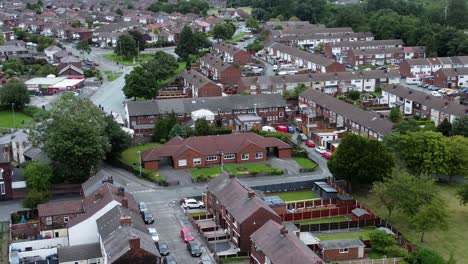 Aerial-view-above-British-neighbourhood-orbit-right-small-town-residential-suburban-property-gardens-and-town-streets