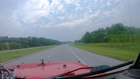 POV---spraying-cleaning-fluid-and-uses-wipers-to-clean-the-windshield-while-driving-on-an-interstate