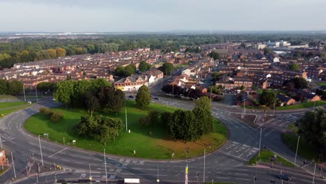Warrington-town-centre-outskirts-aerial-view-above-industrial-suburban-roundabout-and-houses-skyline-pan-right