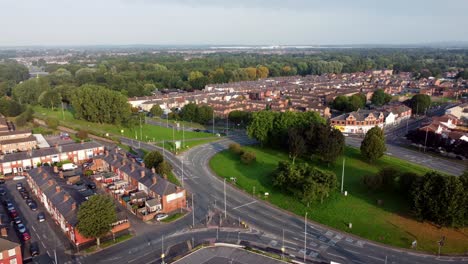 Warrington-town-centre-outskirts-aerial-view-above-industrial-suburban-roads-and-houses-skyline-panning-right