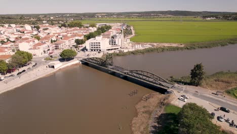 Aerial-orbiting-shot-around-rodoviaria-bridge-with-traffics-crossing-sado-river-and-parish-townscape