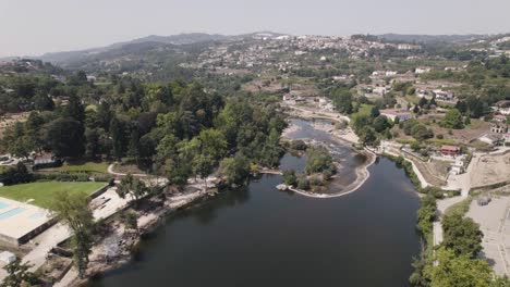 Fly-over-meandering-Tamega-River,-Amarante,-Minho,-Portugal
