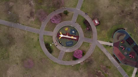 Aerial-rising-orbit-over-outdoor-circular-playground,-Buenos-Aires