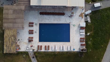 Cinematic-drone-shot-zooming-out-of-a-pool-revealing-the-entire-site