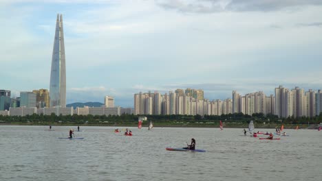 People-kayaking,-windsurfing,-paddle-boarding,-and-enjoying-a-picturesque-day-on-the-Han-River-in-Seoul,-South-Korea