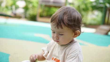 Beautiful-Caucasian-Toddler-Playing-Outdoor-During-Daytime.-Closeup