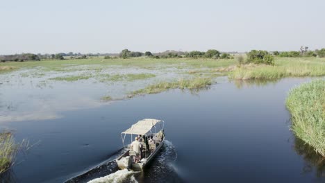 Boat-sailing-on-calm-waters-of-Cuando-River-in-Caprivi-Strip,-Namibia