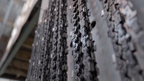 Close-up-of-chainsaw-chains-hanging-in-garage,-steel-chains-in-lumber-industry