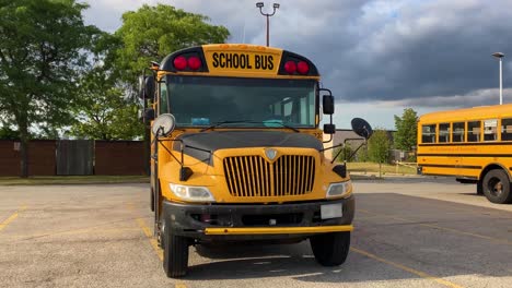 Wide-shot-of-new-full-size-school-bus-showing-lettering,-red-stop-lights-and-mirrors