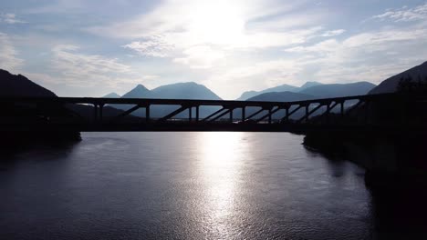 Cars-Driving-over-Ballachulish-Bridge-at-Loch-Leven-near-Glencoe-on-the-West-Coast-of-Scotland-with-Morning-Sun,-Aerial-Drone-4K-HD-Footage-Fly-Left