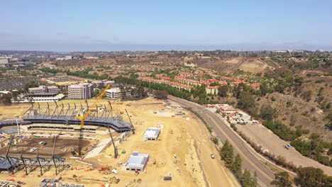 Unfinished-stadium-construction-in-Mission-Valley,-San-Diego,-drone-backwards
