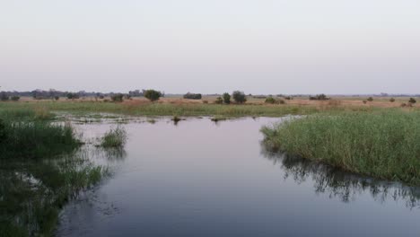 African-river-in-grassland-savannah,-wildlife-river-crossing-migration