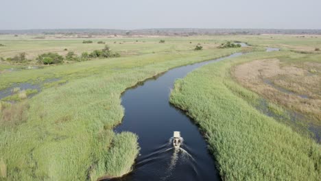 Aerial-View-as-Passenger-Boat-Cruises-Up-Cuando-River-in-Caprivi-Strip,-Africa