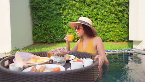 Breakfast-in-Floating-Plate-and-Sexy-Exotic-Woman-in-Swimming-Pool,-Luxury-Vacation-Concept,-Slow-Motion-Full-Frame