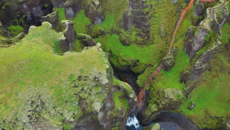 Green-Lush-Canyon-With-Steep-Rocks---Fjaðrárgljúfur-In-South-East-Iceland---aerial-orbit
