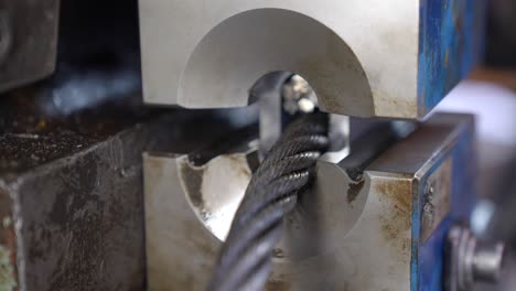 Pulling-steel-wire-rope-through-talurit-swaged-sleeve-in-hydraulic-press,-creating-loop