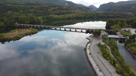 Aerial-dramatic-shot-of-a-bridge-above-Haliacmon-Aliakmon-river-in-northern-Greece-Macedonia