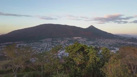 Drone-Flying-Over-Trees-Reveal-Santa-Tecla-Municipality-With-San-Salvador-Volcano-And-National-Park-In-El-Salvador