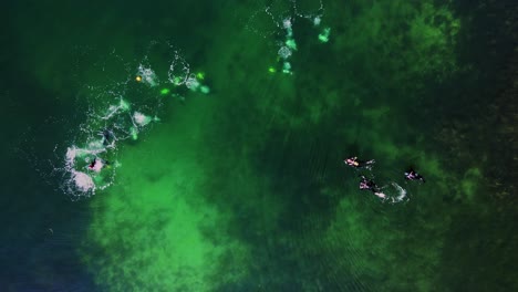 Aerial-View-Of-Divers-Swimming-And-Exploring-Marine-Life-Under-The-Sea-Near-Slaggo-Island-In-Lysekil,-Sweden