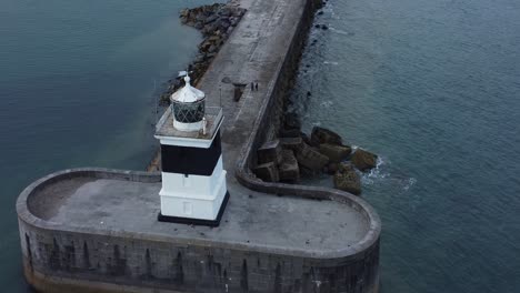 Holyhead-breakwater-lighthouse-longest-concrete-coastal-sea-protection-landmark-aerial-view-birdseye-rising-right