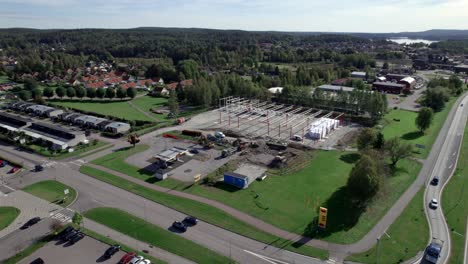 Construction-Site-With-Excavator-and-Crane,-Aerial-Dolly-in-Nordic-Country