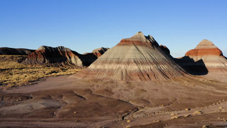 Arizona-landscape:-Teepees-of-Painted-Desert-with-blue-sky,-drone-dolly-shot