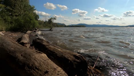 A-time-lapse-of-the-beautiful-hudson-river-in-new-york's-hudson-valley-during-early-autumn-on-a-sunny-day-with-blue-skies-and-beautiful-clouds