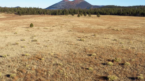Dry-deserted-land-around-steep-Cinder-cone-volcanic-lava-mountain