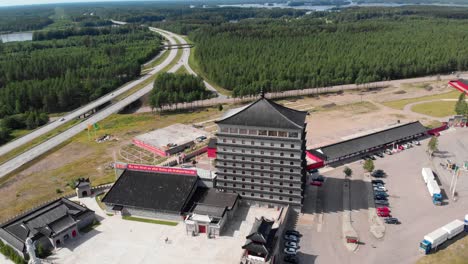 Pagoda-hotel-at-Unfinished-Dragon-Gate-Center-in-Sweden,-Aerial-Reveal