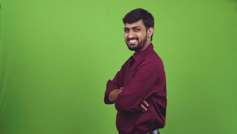 Handsome-man-with-white-smile-standing-confidently-and-turning-towards-camera,-isolated-on-green-screen