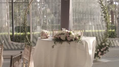 Dramatic-zoom-of-the-floral-arrangement-and-decoration-on-a-bride-and-groom's-table