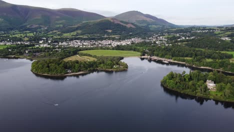 Keswick-town-viewed-over-Derwent-water-Lake-District-Cumbria-UK-Summer-aerial-footage