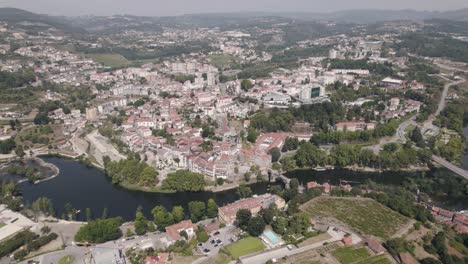Birds-eye-view-featuring-parish-townscape,-tamega-river-and-famous-Sao-Goncalo-monastery