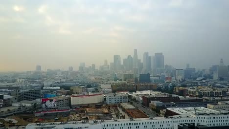 Overcast-misty-aerial-view-across-downtown-Los-Angeles-cityscape-high-rise-skyline-dolly-right