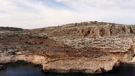 Aerial-drone-video-from-Malta,-Ghar-Lapsi,-flying-toward-the-beautiful-and-high-cliffs