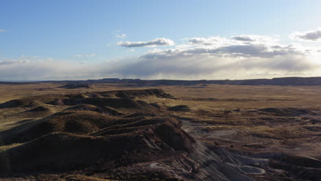 Drone-flying-over-a-dusty-badland-to-get-a-panoramic-view-of-the-location