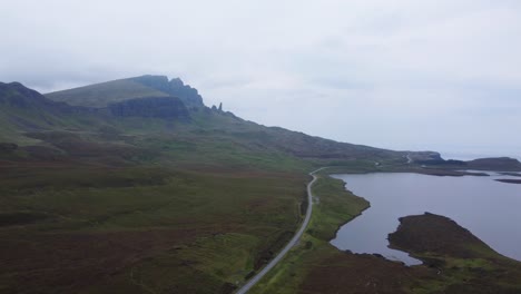 Road-leading-to-Old-Man-of-Storr,-Famous-Landmark-on-Isle-of-Skye,-West-Coast-of-Scotland---Aerial-Drone-4K-HD-Footage-Pan-Right