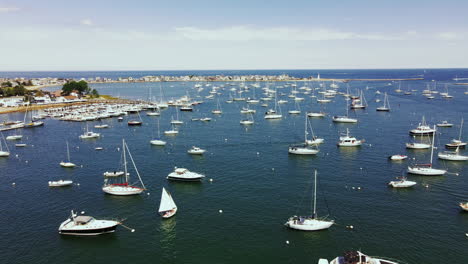 Drone-footage-of-Scituate-Harbor-in-MA,-Low-long-push-forward-showing-multiple-boat-and-yachts