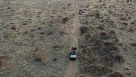 Aerial-Pull-Back-Reveal-Safari-Jeep-And-Stunning-Landscape,-Namibia